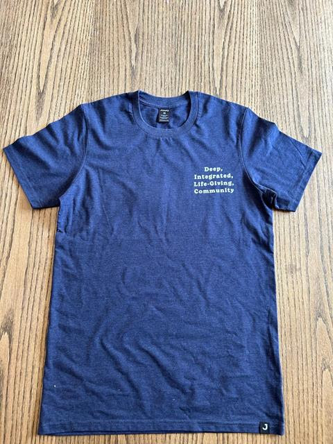 Crow 2024 Staff T-Shirt: it's heather blue, and says "deep integrated life-giving community" on the front
